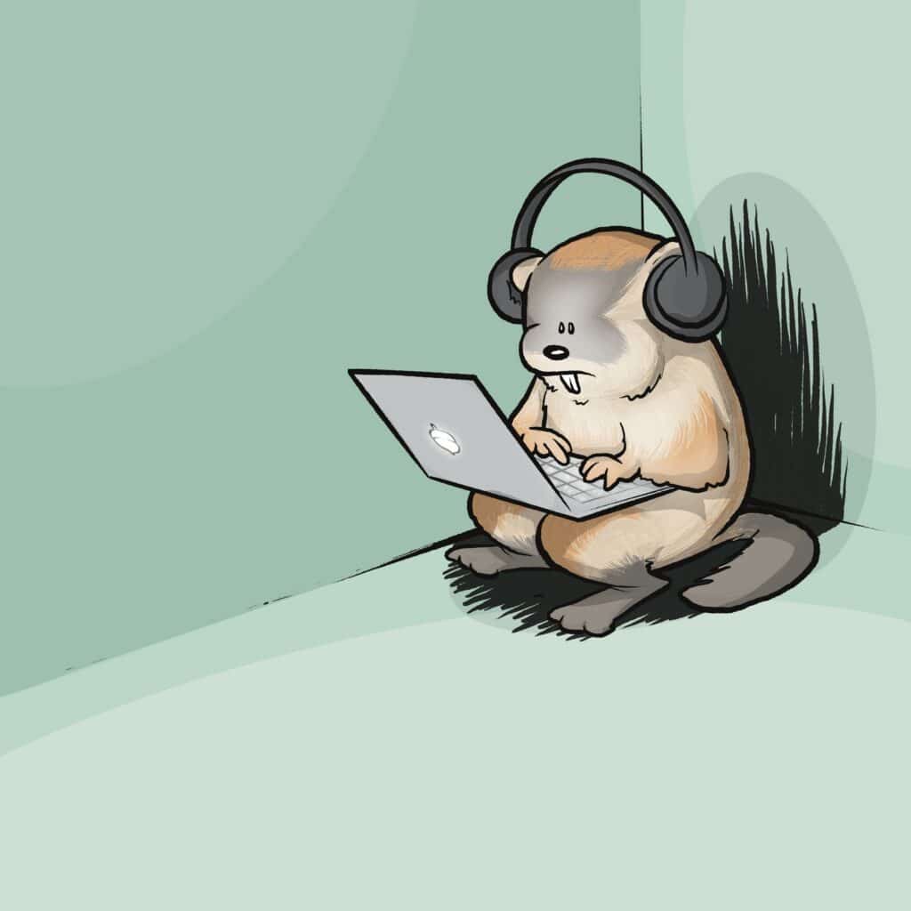 A woodchuck wearing big headphones types on a laptop, tucked alone into the corner of an empty room.