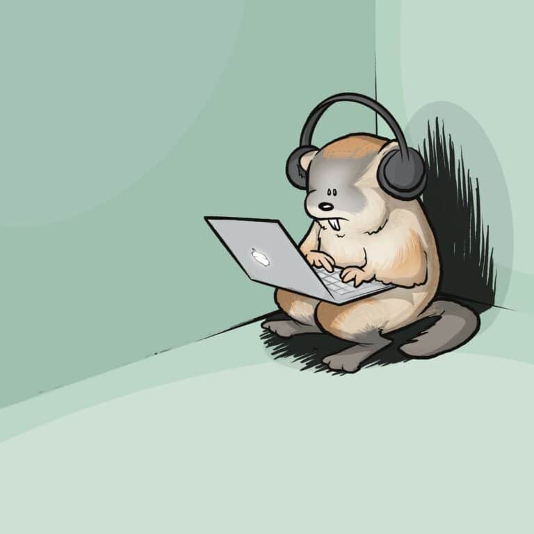 A woodchuck wearing big headphones types on a laptop, tucked alone into the corner of an empty room.